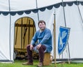 A medieval armorer sits outside his tent Royalty Free Stock Photo