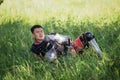 A medieval Asian warrior in armor is resting while sitting in tall grass Royalty Free Stock Photo