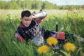 A medieval Asian warrior in armor is resting while sitting in tall grass Royalty Free Stock Photo