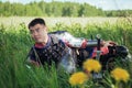 A medieval Asian warrior in armor is resting while sitting in tall grass Royalty Free Stock Photo