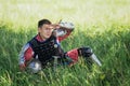 A medieval Asian warrior in armor is resting while sitting in tall grass Royalty Free Stock Photo