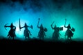 Medieval battle scene with cavalry and infantry. Silhouettes of figures as separate objects, fight between warriors on dark toned Royalty Free Stock Photo