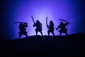 Medieval battle scene with cavalry and infantry. Silhouettes of figures as separate objects, fight between warriors on dark toned Royalty Free Stock Photo
