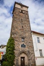 Medieval black gothic tower in center of Plzen in sunny summer day, masonry wall, prismatic water tower, pyramidal roof, part of