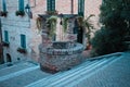 A medieval brick water well in the middle of a staircase in an ancient Italian village Corinaldo, Marche Royalty Free Stock Photo