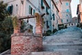 A medieval brick water well in the middle of a staircase in an ancient Italian village Corinaldo, Marche Royalty Free Stock Photo