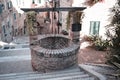 A medieval brick water well in the middle of a staircase in an ancient Italian village Corinaldo, Marche Royalty Free Stock Photo