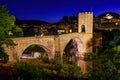 Medieval bridge that crosses the river in the ancient city of Besalu at night, Gerona, Spain. Royalty Free Stock Photo