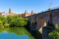 Medieval bridge over the Tarn river in Montauban city on sunny day