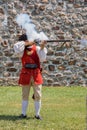 A medieval british officer shoots a gun at fort Frederick