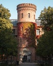 The medieval building called Kungshuset filled with ivy turning red during autumn in Lund Sweden
