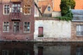 Medieval building facades on river canals in old town Brugge Bruges, Belgium. Vintage houses with wooden door and windows.