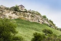 Medieval building on a high cliff above the mountain valley in the famous ancient city-fortress of Chufut-Kale Royalty Free Stock Photo