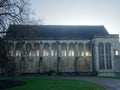 Medieval building with stained glass windows at sunset.