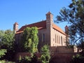 Medieval castle with brick walls, towers, tiled roof in architectural Gothic style in Poland