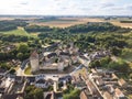 Medieval castle with fortified walls, towers and donjon in rural village in France, aerial view from drone of renovated fortress Royalty Free Stock Photo