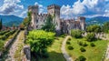 Medieval castle on mountains background, scenic view of old fortress, sky and green plants, stunning landscape. Theme of nature,