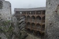 Medieval castle ruin courtyard in heavy fog