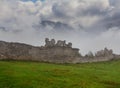 Medieval castle ruin in green mountain valley Royalty Free Stock Photo