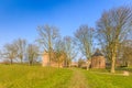 Medieval castle Slot Loevestein with powder tower surrounded by earthen wall and moat at River Waal