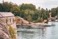 Medieval castle walls near lake shore. Autumn forest, daylight. Royalty Free Stock Photo