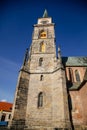 Medieval catholic church of Saint Jilji with gothic High clock tower in sunny autumn day, Nymburk, Central Bohemia, Czech Republic Royalty Free Stock Photo