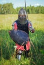 A medieval Central Asian warrior a nomad in 14th-century armor stands in a defensive or attacking position