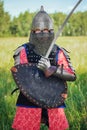 A medieval Central Asian warrior a nomad in 14th-century armor stands in a defensive or attacking position