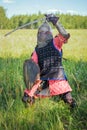 A medieval Central Asian warrior a nomad in 14th-century armor stands in a defensive or attacking position