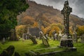 Medieval church and ancient graves in Glendalough Cemetery with autumn forest and mountains, Ireland Royalty Free Stock Photo