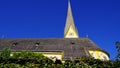 Steep perspective church with yellow facade under blue sky Royalty Free Stock Photo