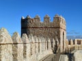 Medieval city walls and rampart against vibrant blue sunny sky, Spain