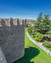 Medieval city walls tower and grass lawn in Avila, Spain