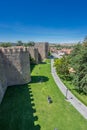 Medieval city walls tower and grass lawn in Avila, Spain.