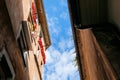 Medieval classic building with flower window against blue skyin Royalty Free Stock Photo