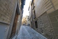 Medieval cobbled and stepped street with flowery balconies and p Royalty Free Stock Photo