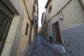 Medieval cobbled and stepped street with flowery balconies and p Royalty Free Stock Photo