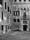 Medieval courtyard in venice with old windows repaired walls a Royalty Free Stock Photo