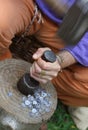 Medieval craftsman while coins coins of lead with hammer and pu