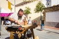 Medieval craftsman making arrows in market