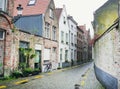 Medieval empty side street of Bruges, Belgium, with a bike parked at one side