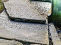 Medieval engraved stone tablets lying and stacked on ground