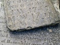 Medieval engraved stone tablets lying and stacked on ground