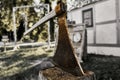 Medieval executioner`s axe used to strike the head of condemned to death is stuck in a raw block of wood, selective focus Royalty Free Stock Photo