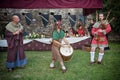 Medieval musicians performing ancient tunes with instruments like bagpipe, bass drum and flute