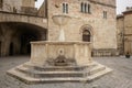 Medieval fountain and San Silvestro Church facade in the main square of the town of Bevagna in Umbria Italy. Royalty Free Stock Photo