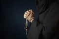 Medieval friar praying with wooden cross in hands Royalty Free Stock Photo