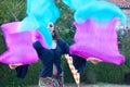 Medieval gipsy girl dancing with a pair of handheld fan