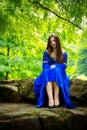 Medieval girl sitting on stone stage Royalty Free Stock Photo