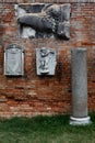 Bas Relief sculptures on brick wall on the island of Torcello, Venice, Italy